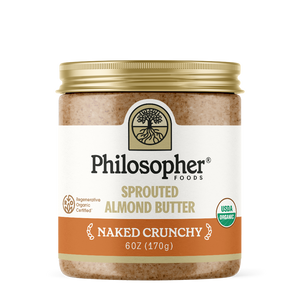 Image displays front of jar. Label displays image of tree with roots, "Philosopher Foods" in bold black text, "Sprouted Almond Butter" in gold, "Naked Crunchy" in white, 6 ounce jar. Also shows label icons for USDA Certified organic and for Regenerative Organic Certified
